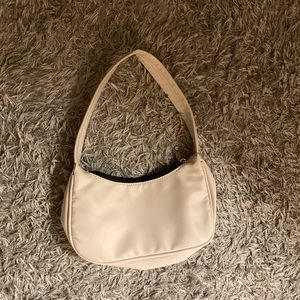 white handbag with black inside